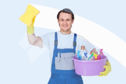 Cleaner Highbury team member preparing cleaning equipment with safety gear